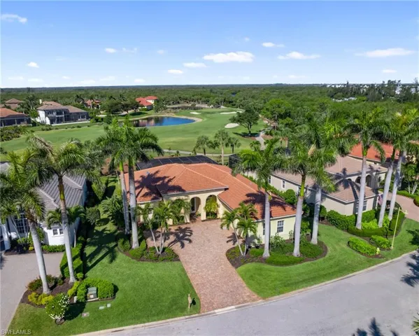 Drone Shot of Home W/ Mature Royal Palms + Golf Course Back Drop