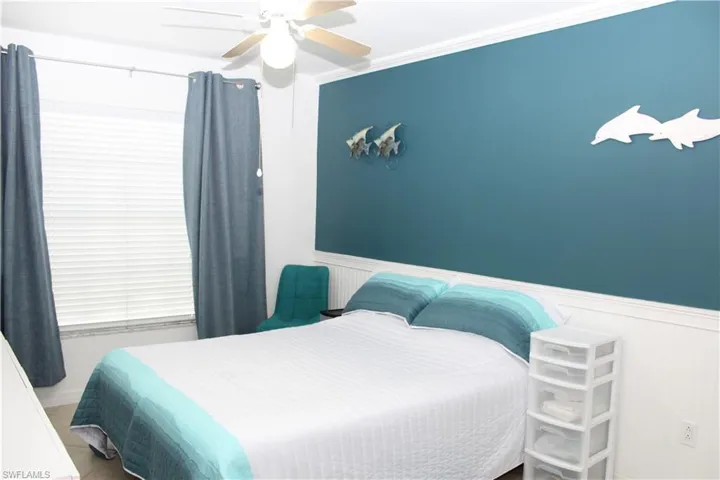 Bedroom featuring ceiling fan and ornamental molding