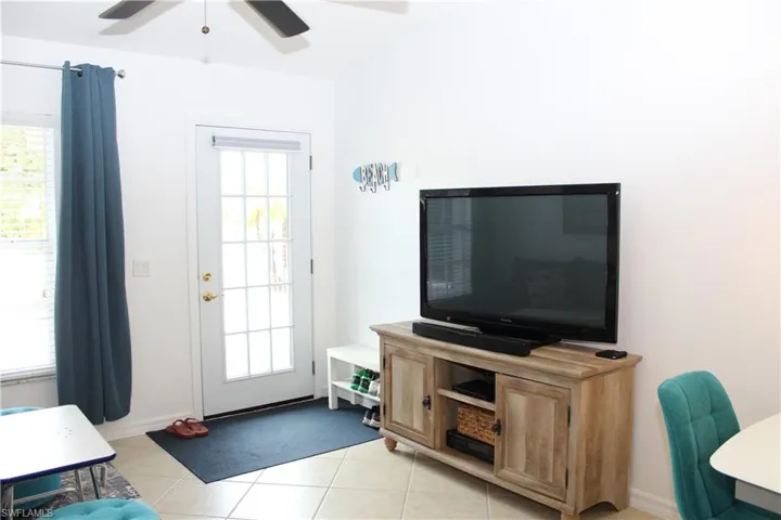 Living room featuring plenty of natural light and light tile patterned flooring