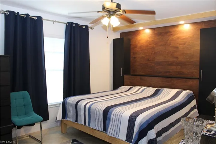 Bedroom with tile patterned floors and ceiling fan