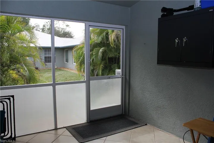 Doorway featuring light tile patterned floors