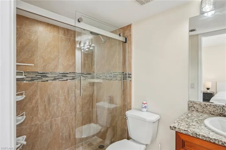 Ensuite bathroom featuring vanity and a stall shower