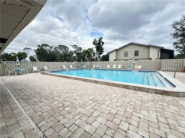 Community pool with a patio