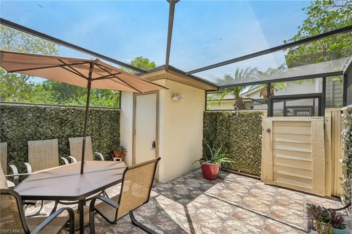 View of patio / terrace with outdoor dining area, a lanai, and a sunroom