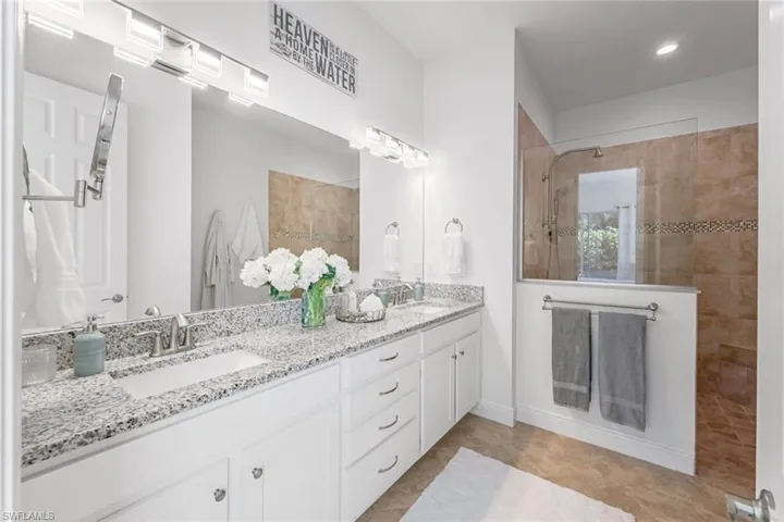 Bathroom with dual vanity and tile floors