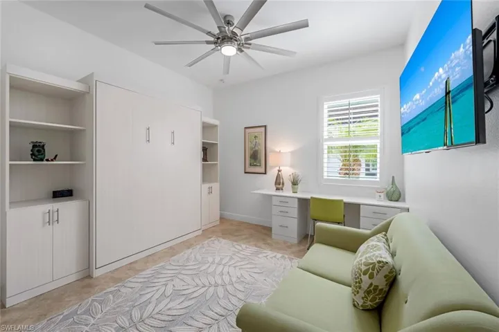 Sitting room featuring ceiling fan and light tile floors