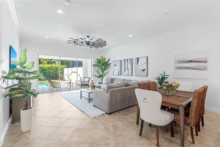 Dining area featuring light tile floors and crown molding