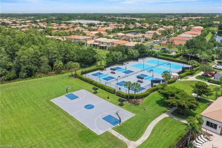 Recreational area featuring a basketball half-court, multiple tennis courts, and pickleball courts