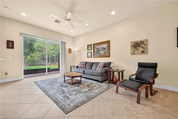 Spacious room featuring neutral wall tones, large format tile flooring, recessed lighting, and a ceiling fan