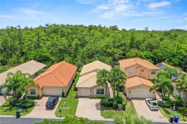 South-facing home featuring a terracotta tile roof and light-colored stucco exterior