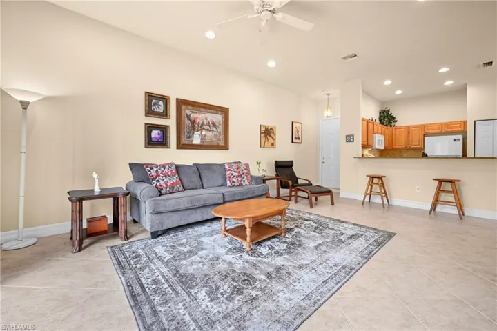 Open concept living space featuring high ceilings, recessed lighting, and tile flooring