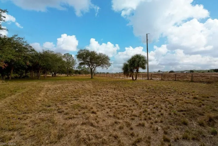 View of yard with a rural view