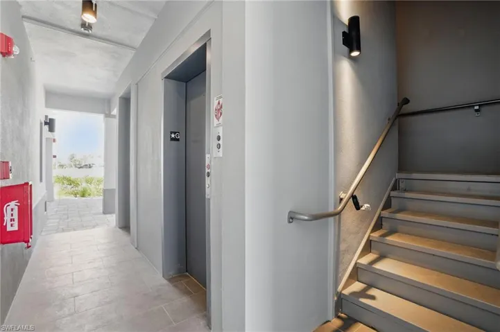 Ground floor entry hall featuring elevator and tile floors - VIRTUALLY EDITED