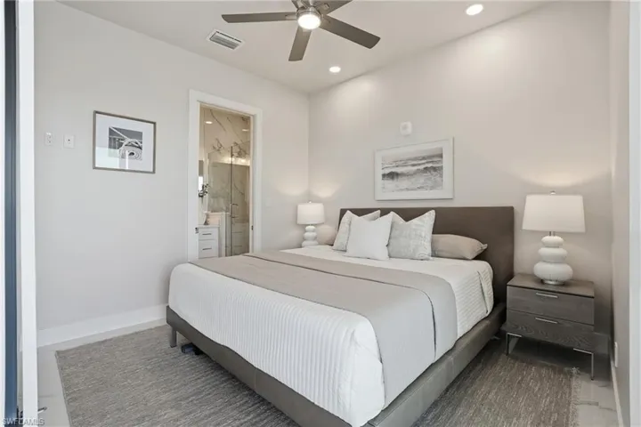 Bedroom with a ceiling fan, ensuite bathroom, and recessed lighting - Virtually Edited Image
