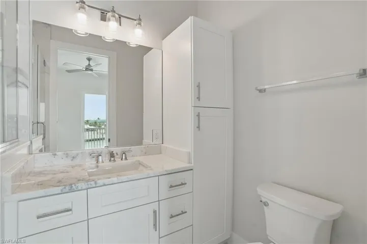 Master Bathroom featuring vanity, toilet, and a ceiling fan - VIRTUALLY EDITED