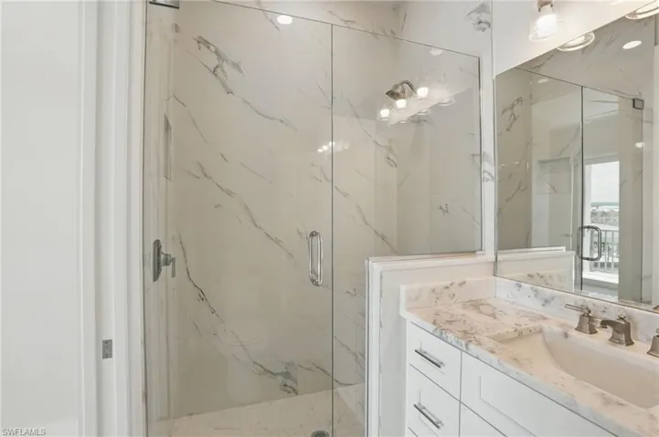 Master Bathroom featuring a marble finish shower and vanity - VIRTUALLY EDITED