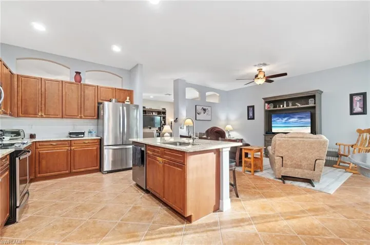 Another view of kitchen and family room showing wall details and overhead lighting.