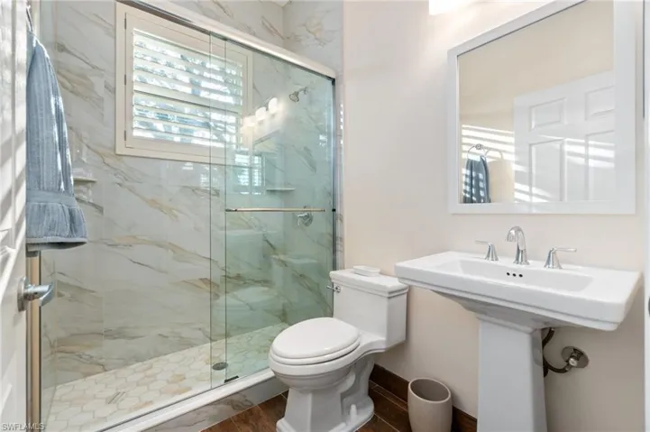 This is the guest bathroom next to guest bedroom.  Beautiful new shower, wood floors.