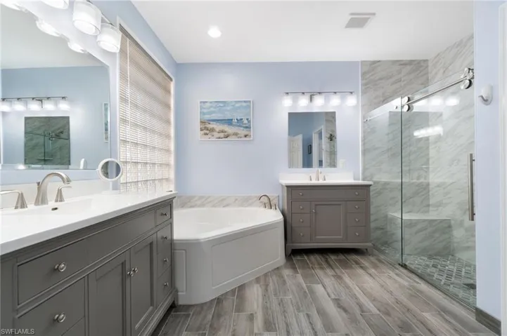 Popular and nondestructive vinyl flooring, double (but separate) vanities/sinks. Tons of electrical and natural light. Exquisite shower and top of the line modern glass doors!