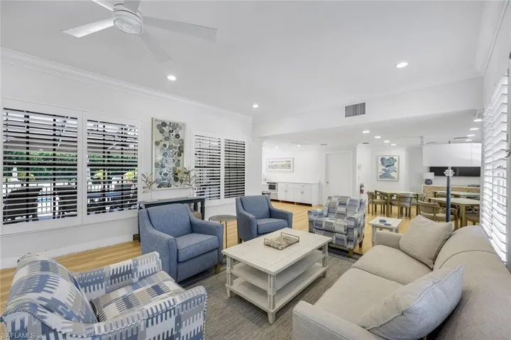 Living room featuring ornamental molding, wood finished floors, and recessed lighting