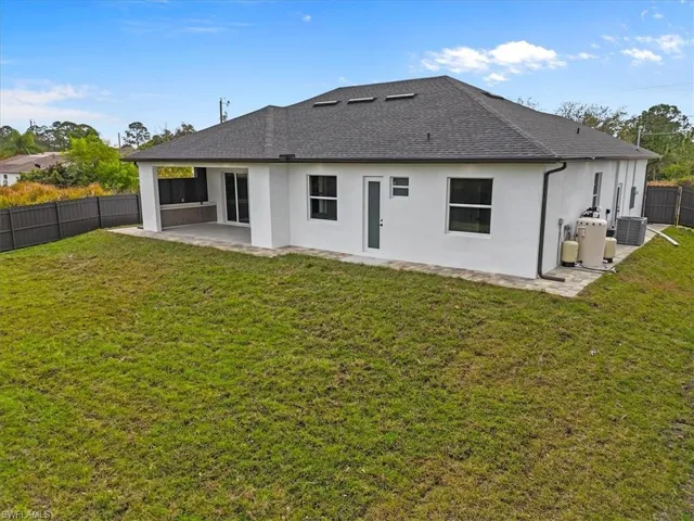 Back of property with a fenced backyard, a patio, stucco siding, and a shingled roof