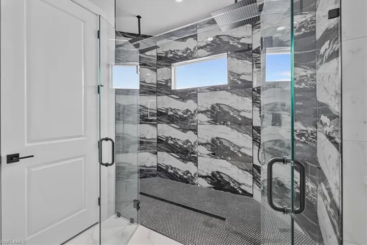 Bathroom featuring a marble finish shower and marble finish flooring