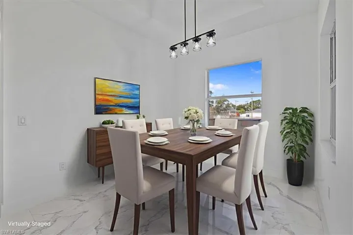 Dining area with light marble finish flooring