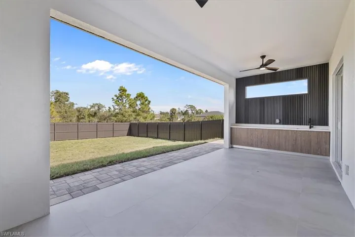 Fenced backyard featuring a patio area and ceiling fan