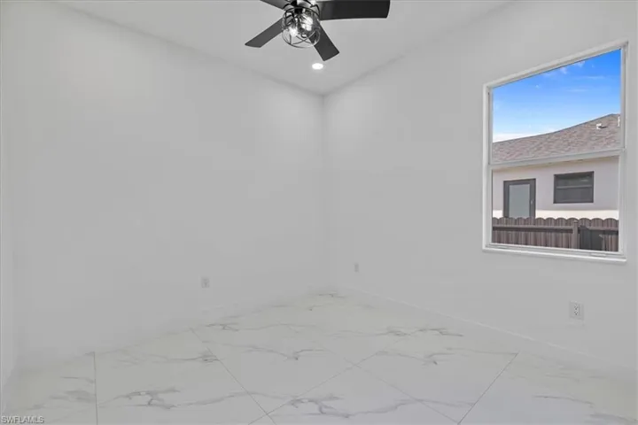 Unfurnished room featuring recessed lighting and light marble finish flooring