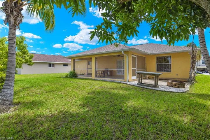 Back of house featuring a patio area and a lawn