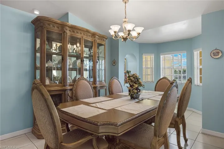 Tiled dining space featuring an inviting chandelier