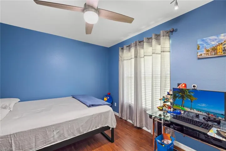 Bedroom featuring dark hardwood / wood-style floors and ceiling fan