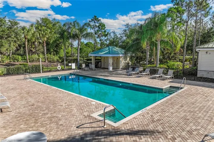 The property features a rectangular swimming pool surrounded by a paver deck