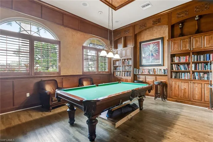 Wood-finish flooring with extensive wood paneling and built-in shelving