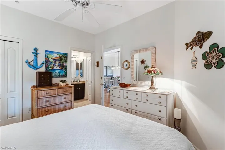 White ceiling fan with light kit, white interior doors, and overhead recessed lighting