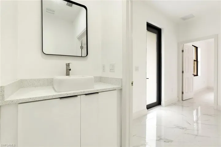 Bathroom featuring marble tiled floors and vanity