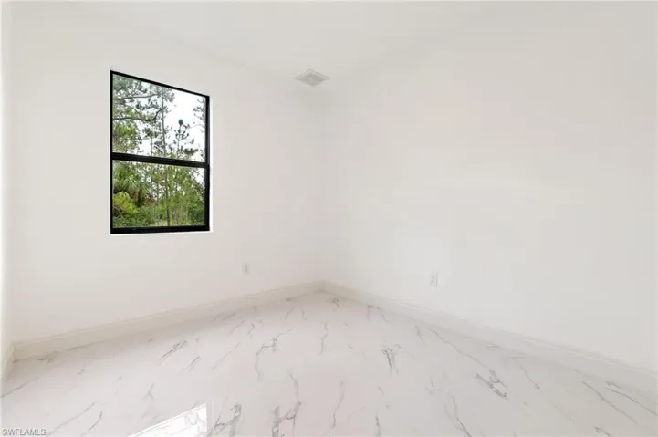 Empty room featuring marble finish flooring