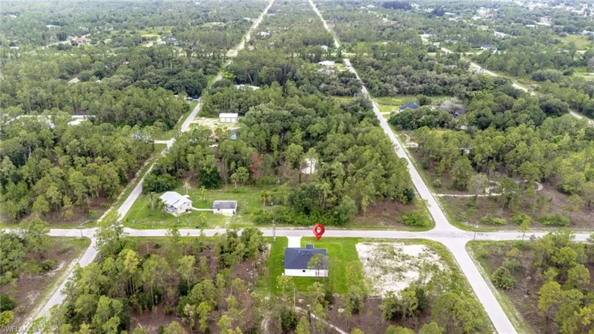 Aerial overview of property's location featuring a forest