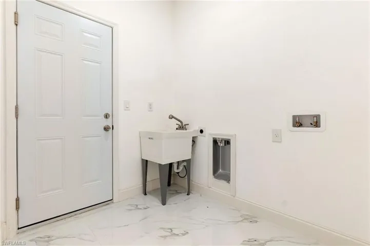 Laundry area featuring marble finish flooring, washer hookup, and hookup for an electric dryer
