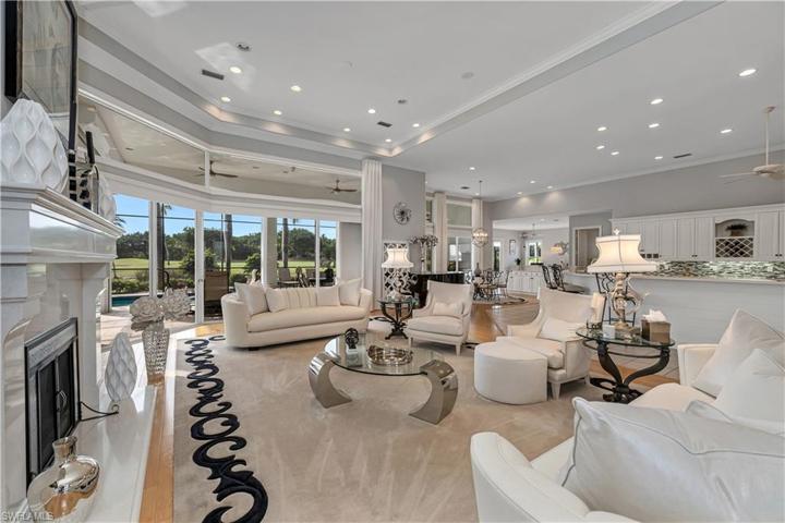 Open living space with custom marble remote controlled fireplace and newer gas logs