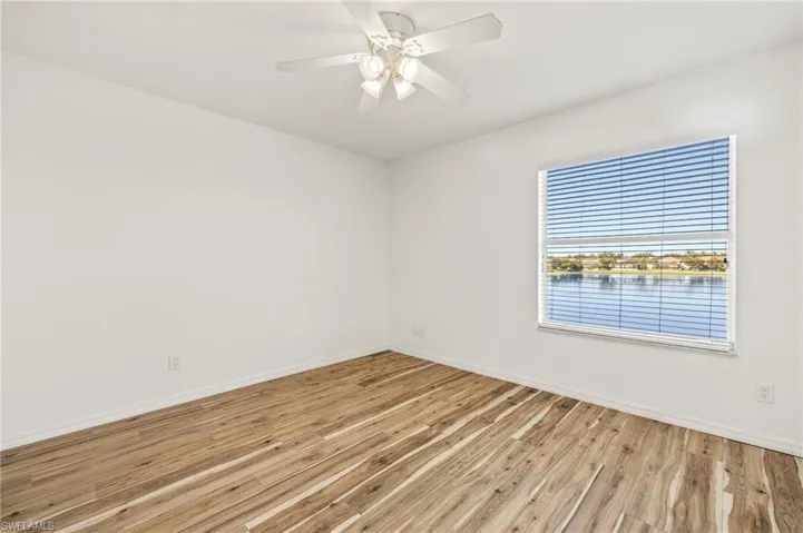 Unfurnished room with light wood-style flooring and a ceiling fan