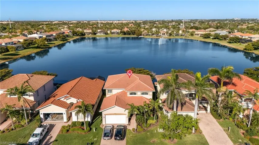 Aerial perspective of suburban area featuring a nearby body of water