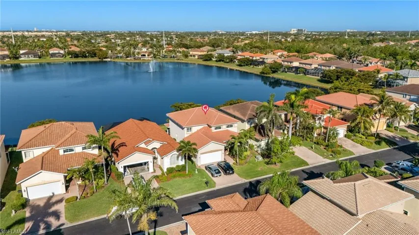 Aerial view of residential area featuring a nearby body of water