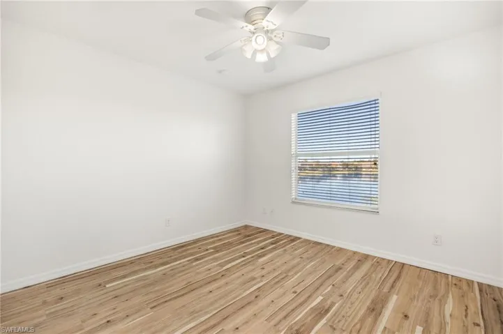 Spare room with light wood-type flooring and a ceiling fan