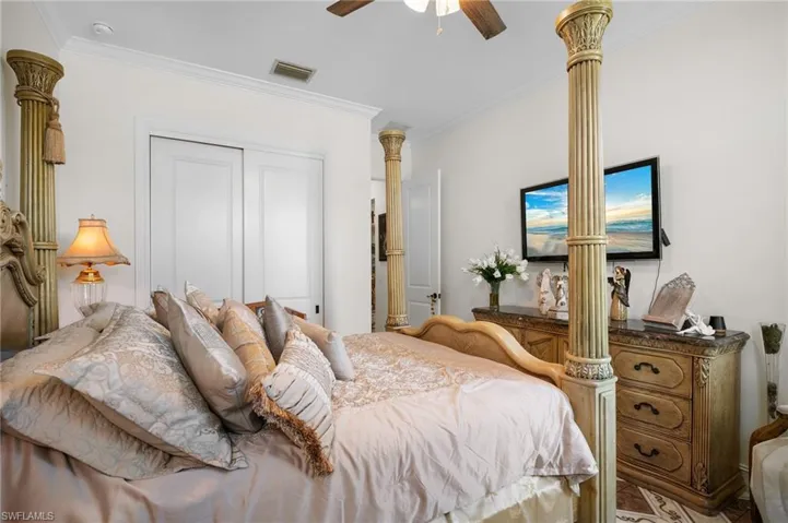 Bedroom featuring crown molding, a closet, and ceiling fan