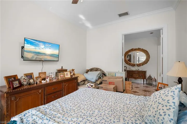 Bedroom featuring crown molding and a ceiling fan