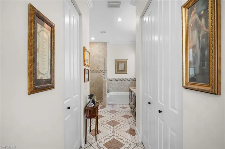 Hall featuring recessed lighting, light tile patterned floors, and ornamental molding
