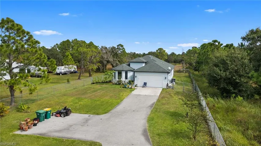 Single story home with asphalt driveway and an attached garage