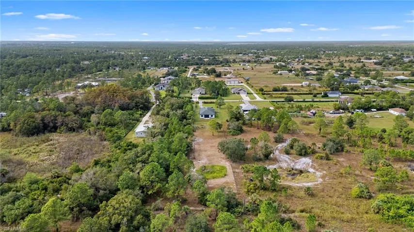 Aerial view of property's location featuring a heavily wooded area