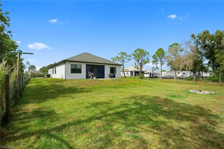 Back of property featuring a fenced backyard and stucco siding
